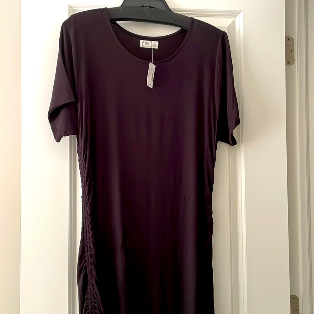 Woman’s plus size T-shirt dress with drawstring rushing on sides.